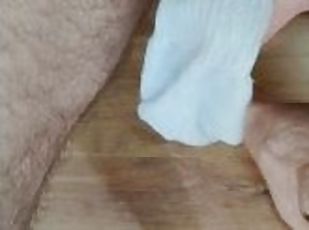 Horny lad wanking his cock using a white sports sock