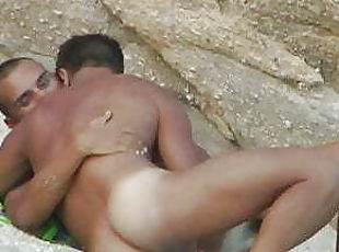 Beautiful sex of a couple on a gay nudist beach