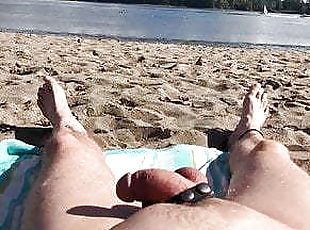 Naked on the beach watching the boats go by.