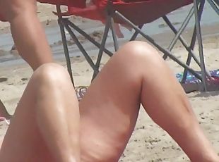 MILF with sexy legs on the beach voyeur video