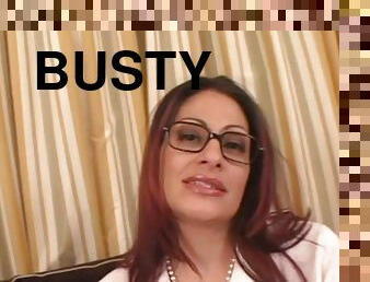 A busty cougar in glasses gives a titjob and rides a dick