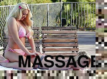 Dashing blonde babe in a bikini gets a sensual massage outdoors