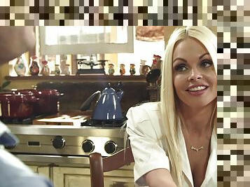 Blonde MILF porn star Jesse Jane embraces her big tits as they are tainted by streams of cumshots