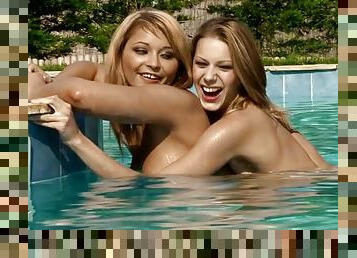 Two naughty lesbians having sex by the poolside