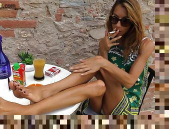 Smoking Italian girl models her pretty feet in close up