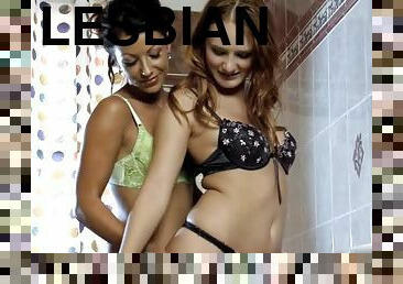 Slutty lesbian chicks finger their pussies lying in the bathtub