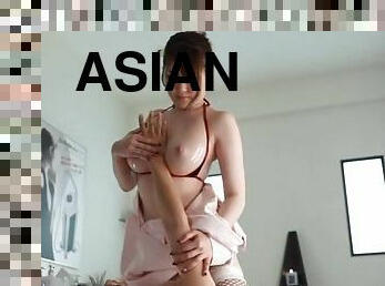 Oiled-up Asian nurse with big tits playing with a stranger's cock