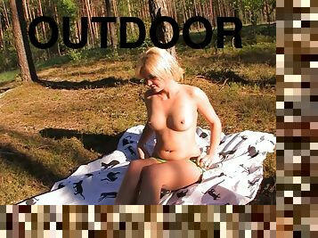 Short haired blonde with puffy labia masturbates in the nature