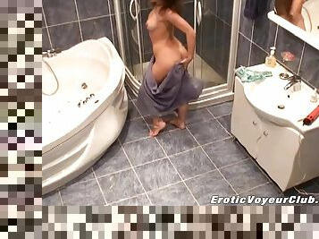 A spy cam video with a slim girl taking a shower