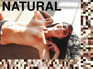 Perfectly shaped Playboy model poses naked lying on the floor