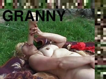 Blonde granny smashes her old cunt with a huge dildo in the garden