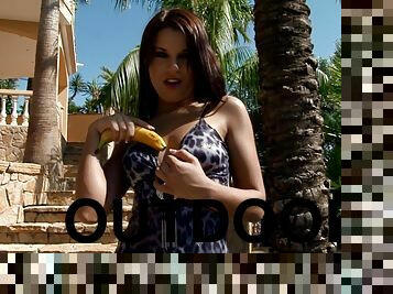 Tanned Venus fingers and stuffs her pussy with a banana