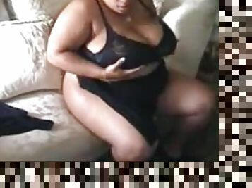 Ebony fattie plays with her enormous boobs indoors