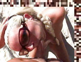 German blonde sucks a dick on a beach and enjoys doggy style sex