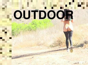 Sexy solo model stripping off showcasing ass outdoor
