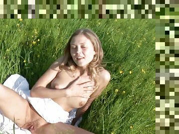 Skinny Russian hottie exhibits her perfect ass in the green field