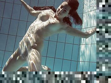 Sexy Sima Lastova reveals her shaved pussy while swimming in the pool