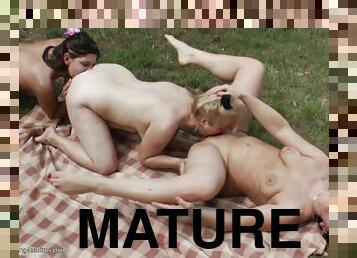 Three naughty sluts lick their muffs during a picnic