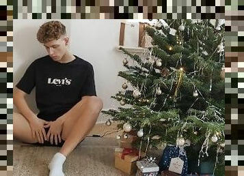 Jakob jerks his uncut cock under the Christmas tree and squirts his sperm on his body