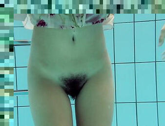 Skinny chick with a hairy twat Lucy strips in the water