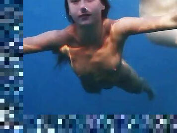 See lean naked bodies underwater in ocean