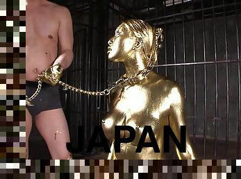 Alluring Japanese chick covered in gold sucks a dick