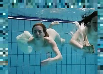 Nearly naked girls go swimming in the pool