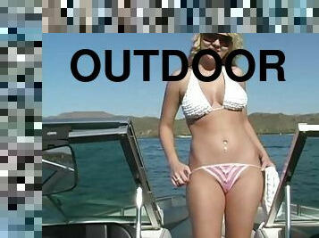 Blonde bombshell Alison Angel takes off her bikini top on a boat