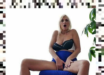 Mature blonde opens her legs to reveal her bald cunt