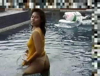 Sexy Charlene gets into water in order to show her buttocks