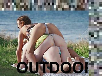 Sensual girls share romantic outdoor threesome moments by the lake