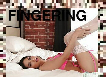 Brunette babe Sunny Leone in solo scene fingering her tight cunt
