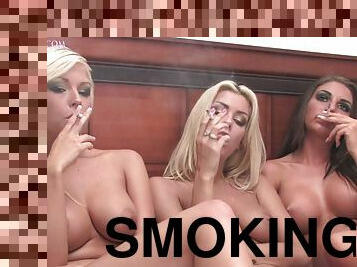 Three topless girls on a smoke break