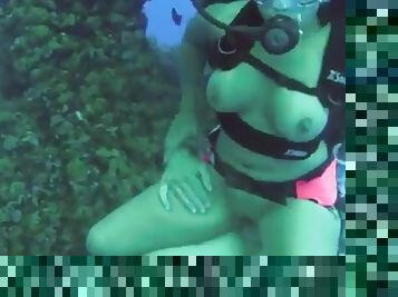 Nasty girl in a diving equipment has a sex on a sea bottom