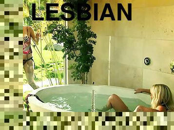 Glamorous lesbian babe getting drilled with a strap on dildo in a bath tub