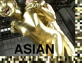 Shiny gold paint covers the Asian girl and her man as they fuck