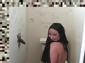Busty brunette giving wild blowjob in toilet through glory hole