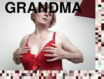 Horny grandma strips down and masturbates on a sofa