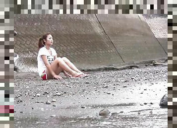 Pretty young brunette takes a walk on the beach