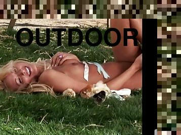 Holley Ann Dorrough poses in the country lying on the ground