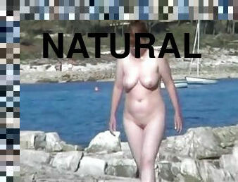 Naturally busty amateur milf gets caught on a cam on nude beach