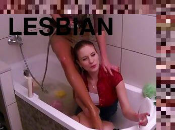 Sexy lesbian MILF receives company of a sexy clothed girl in the tub