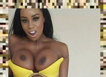 An ebony girl with fake tits gets banged in her shaved cunt