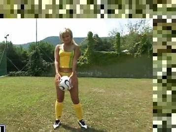 Nasty blonde Candy toys her asshole on a football field