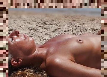 Nice tan on the sexy tits of a beach girl