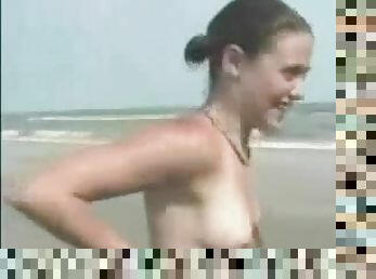 Lovely girl strips off for a bet on the beach