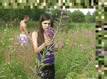 Romantic sex in a field of flowers with a cute brunette teen