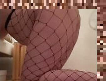 Sexy young woman in fishnets ready for doggy