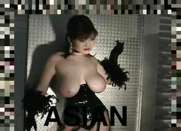 Asian with big boobs poses in a corset