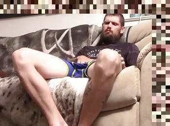 Bearded jock Nolan jerks a big cock solo